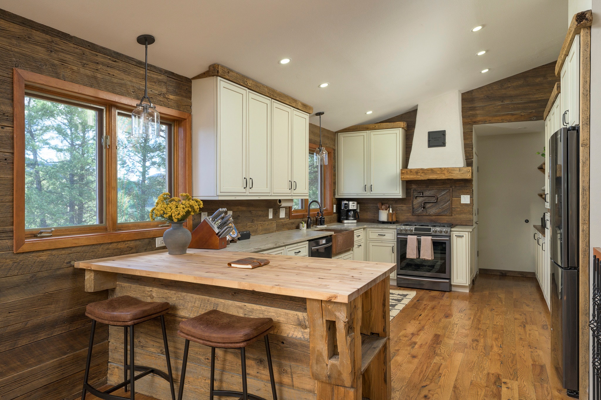Rustic kitchen with cream cabinets and wood island